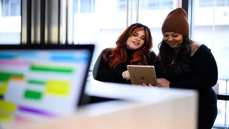 Salon owner reviewing a simple list of review counts by stylist on a tablet